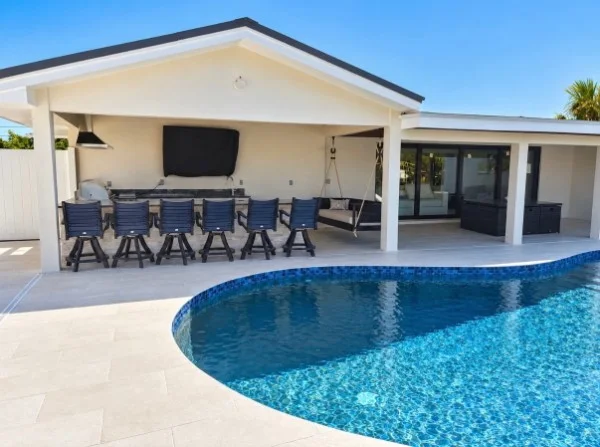 Curved pool and covered outdoor dining